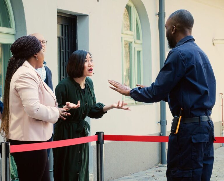 Security guard asking people to wait
